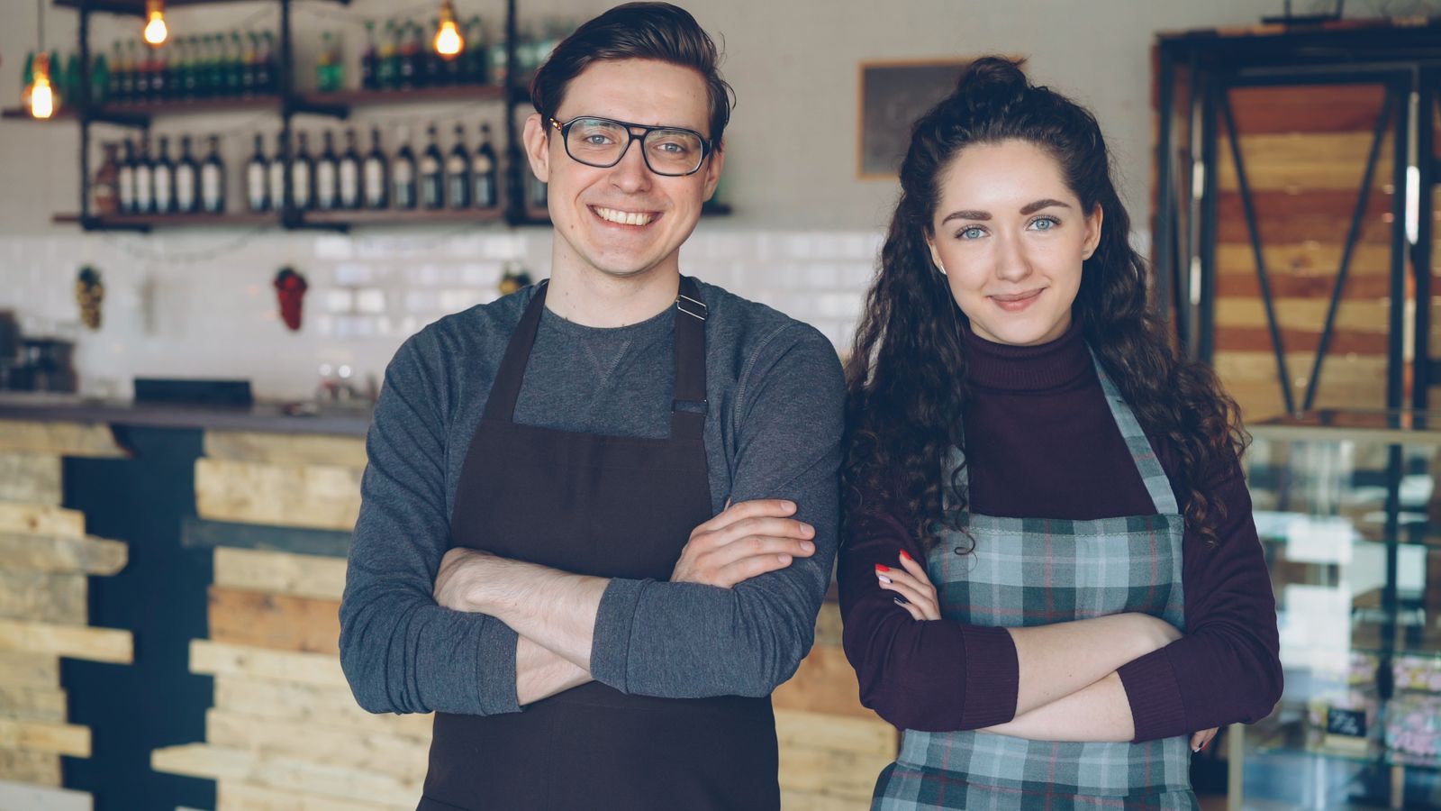 Two small business owners at their cafe counter